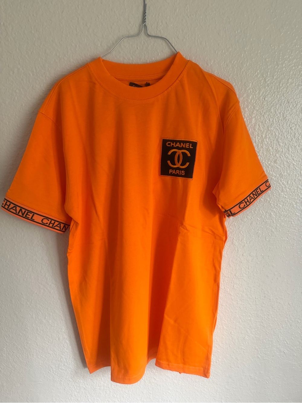 CHANEL Orange Crewneck Tee with Black Logo Patch
